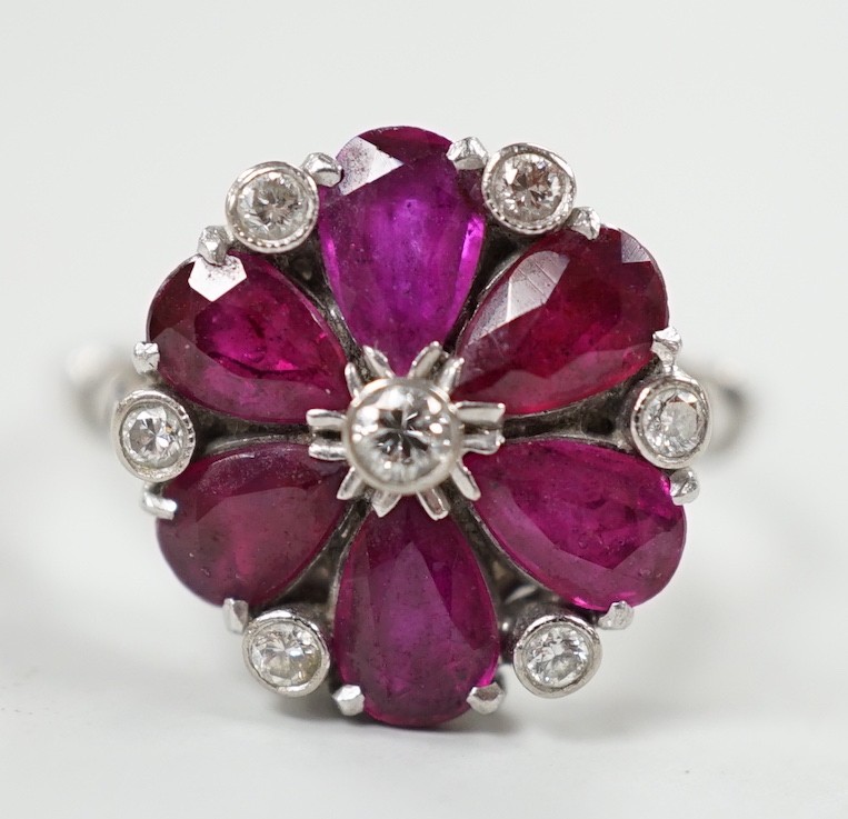 An 18ct & plat, pear cut ruby and diamond chip cluster set ring, size N/O, gross weight 4.8 grams.